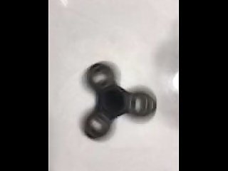 Sexy hand spins a fidget spinner